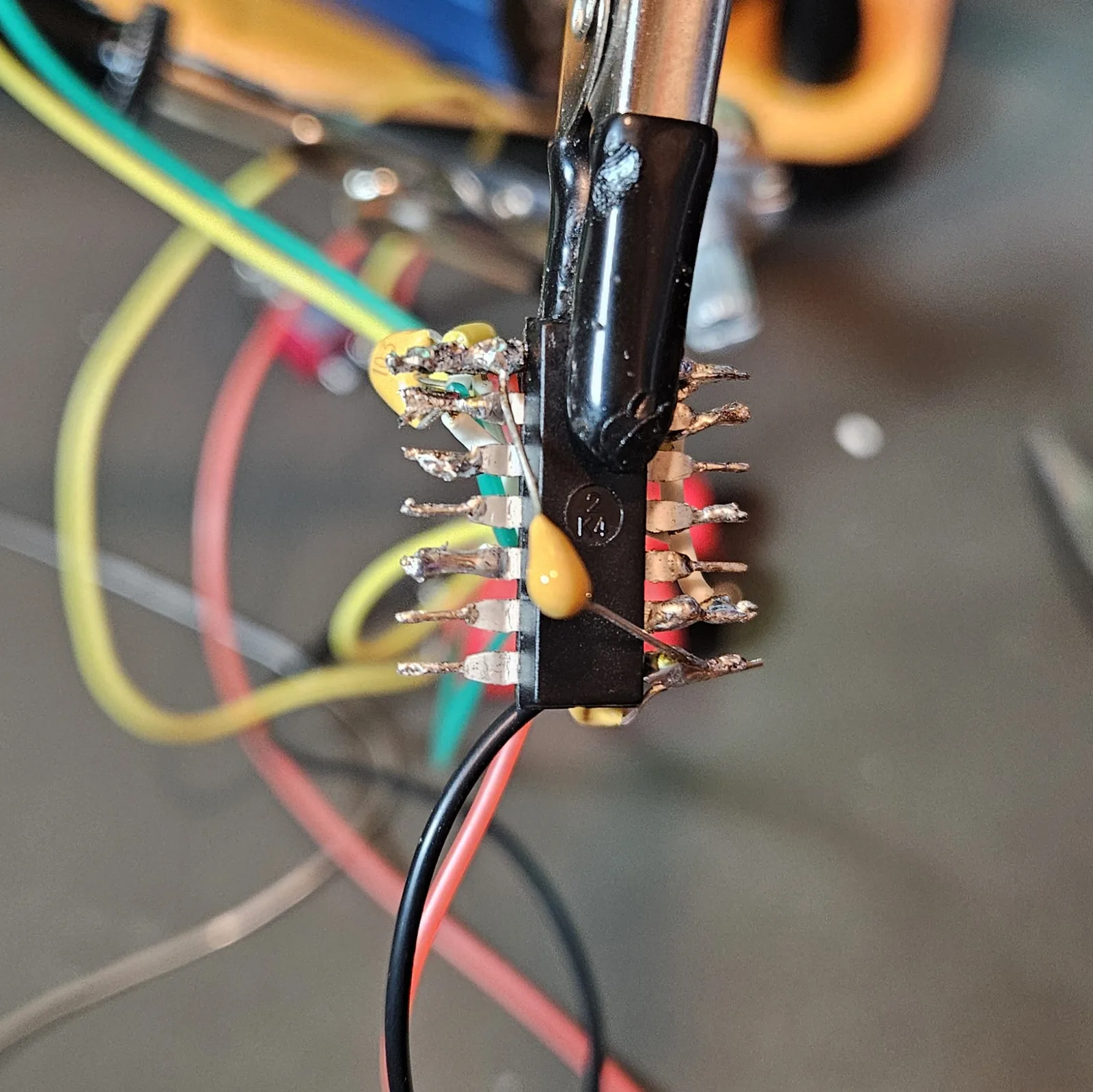 A second yellow ceramic timing capacitor soldered on for timer B, tying its threshold and discharge pins down to ground.