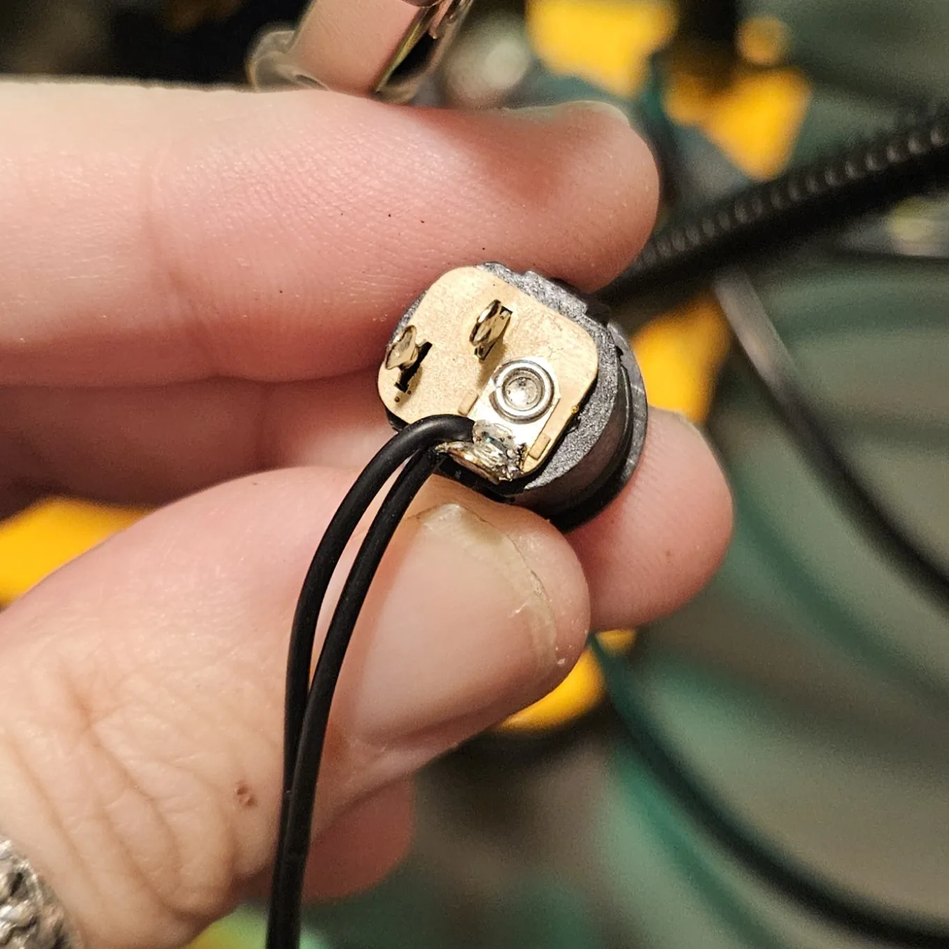 The DC jack with two black ground wires soldered to its sleeve lug.