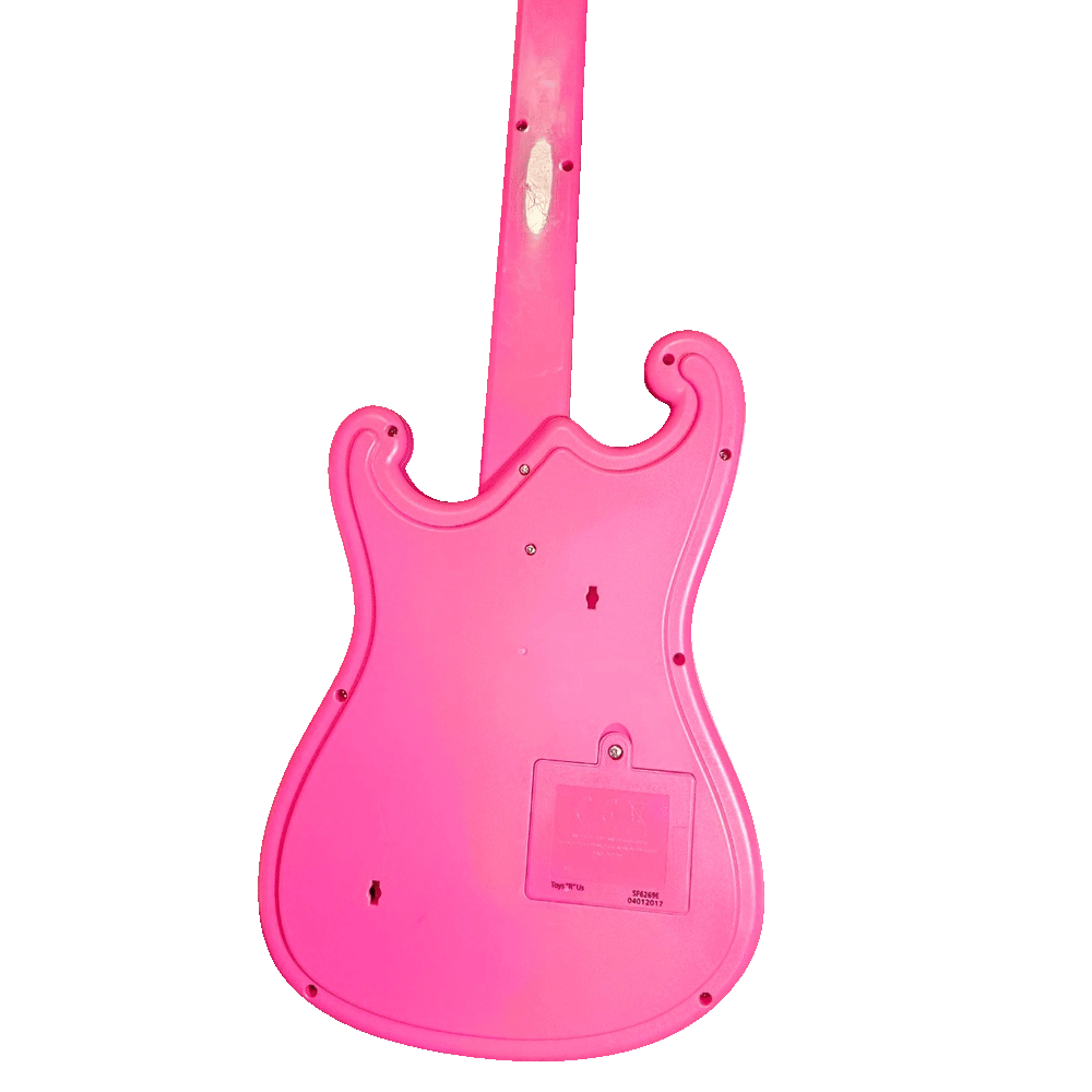 Back of the guitar: plain glossy pink moulded plastic with no added controls, a ring of assembly screws around the body edge and two keyhole-shaped hanging slots. A rectangular battery door with a single screw sits low on the body, and the moulded panel beside it is printed "Toys 'R' Us" with the codes "SF6269E" and "04012017".