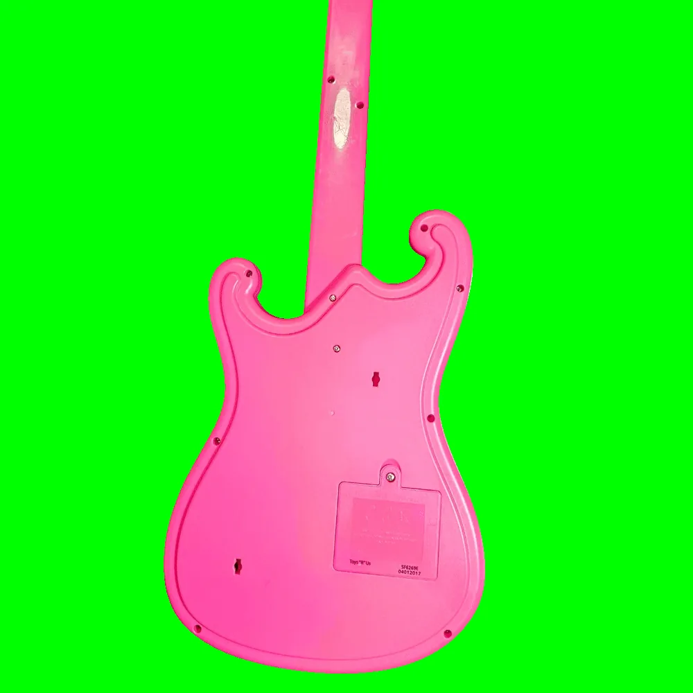 Back of the guitar: plain glossy pink molded plastic with no added controls, a ring of assembly screws around the body edge and two keyhole-shaped hanging slots. A rectangular battery door with a single screw sits low on the body, and the molded panel beside it is printed "Toys 'R' Us" with the codes "SF6269E" and "04012017".
