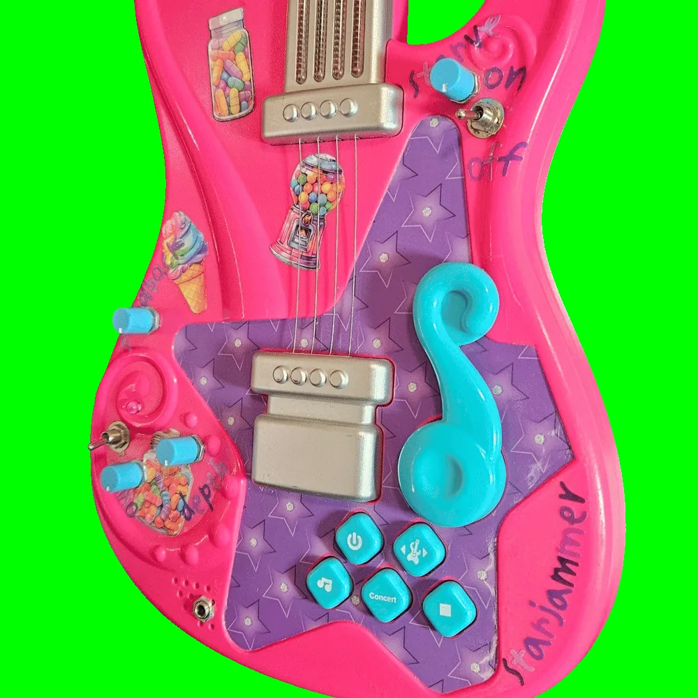 Close-up of the lower body: four small turquoise knobs and two chrome toggle switches added into the hot-pink shell around the original silver pickups, the turquoise treble-clef whammy bar and the factory buttons marked with a power symbol, a music note and "Concert". Handwritten purple marker labels read "starve", "on" and "off" beside the upper toggle and "depth" beside two of the knobs; a silver quarter-inch jack is mounted at the bottom edge next to the speaker slots, and "starjammer" is written in purple marker along the lower right curve. Candy stickers - a jar of sweets, a gumball machine, an ice cream cone and a heart-shaped candy jar - are stuck across the pink areas.