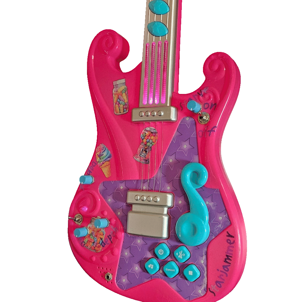 The same guitar in a dim room with the lights running: the four clear plastic string strips on the neck glow hot magenta-pink from end to end, and a smaller pink glow shows inside the moulded swirl at the lower left of the body. The added knobs, toggles and marker labels stay visible in the low light.