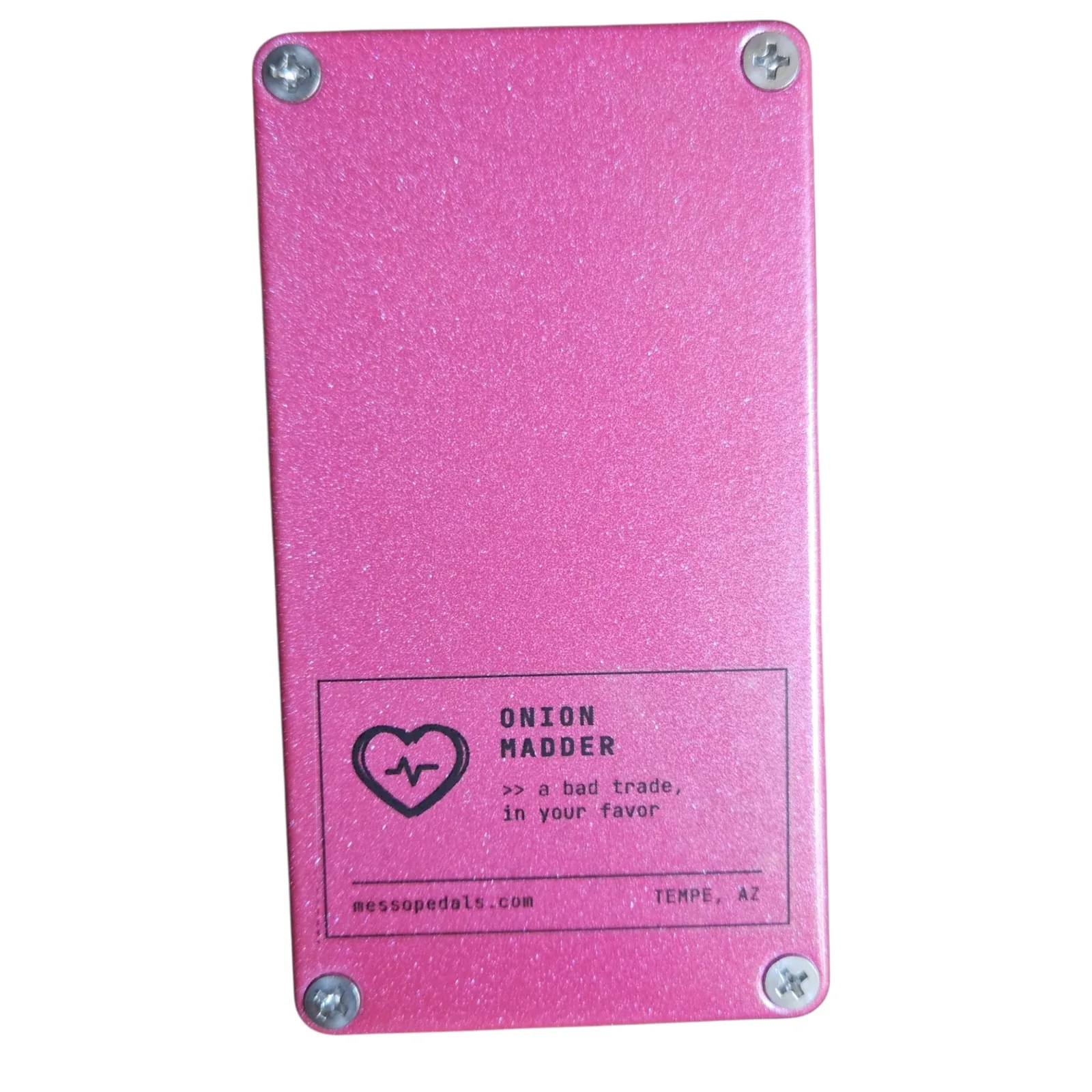 The back plate of the pink box with a screw in each corner and a white label near the bottom: a heart with a heartbeat line, ONION MADDER, a bad trade, in your favor, messopedals.com and TEMPE, AZ.