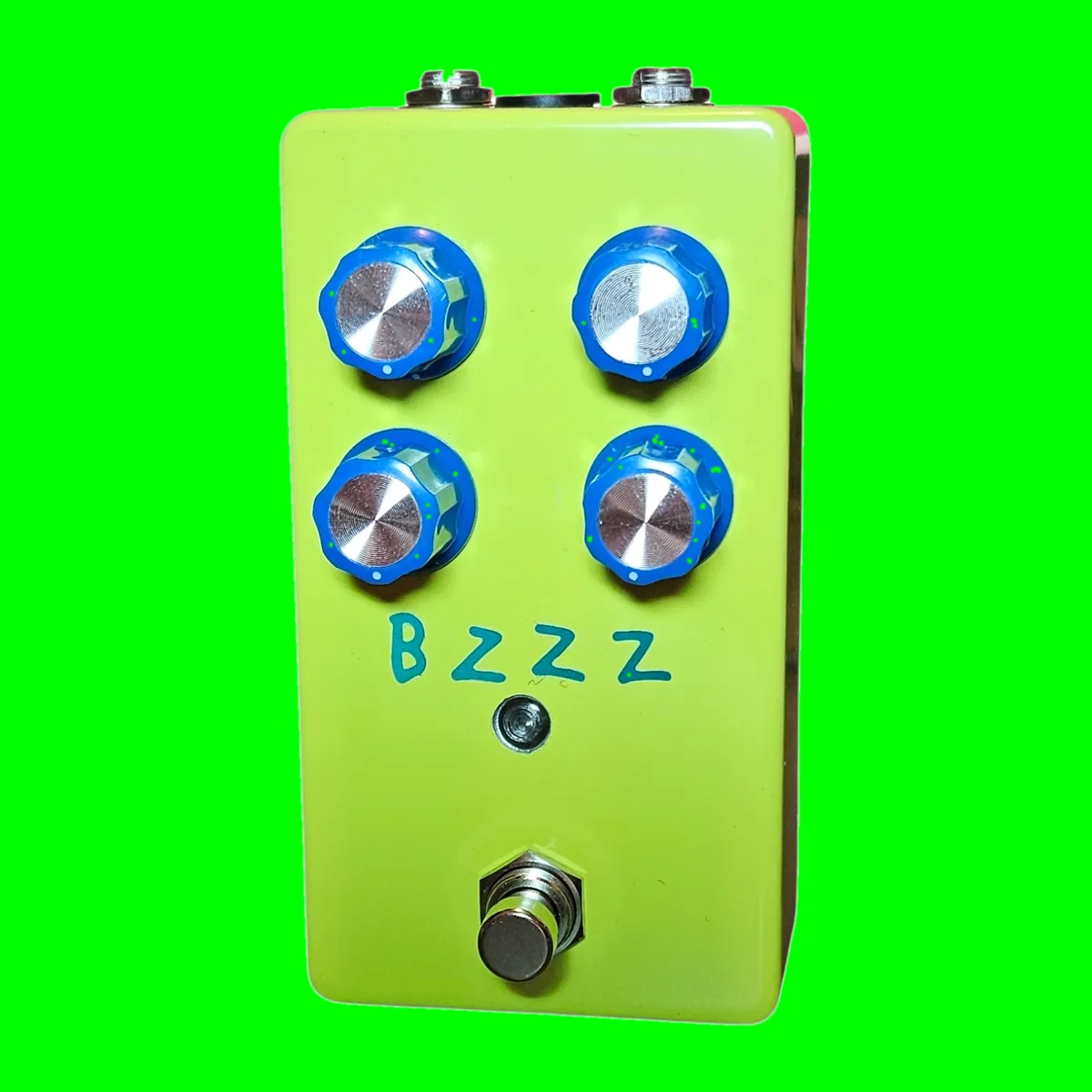 Bzzz pedal - neon yellow-green enclosure, four chunky blue-and-silver knobs, small LED, 3PDT footswitch, hand-lettered BZZZ in teal marker beneath the knobs