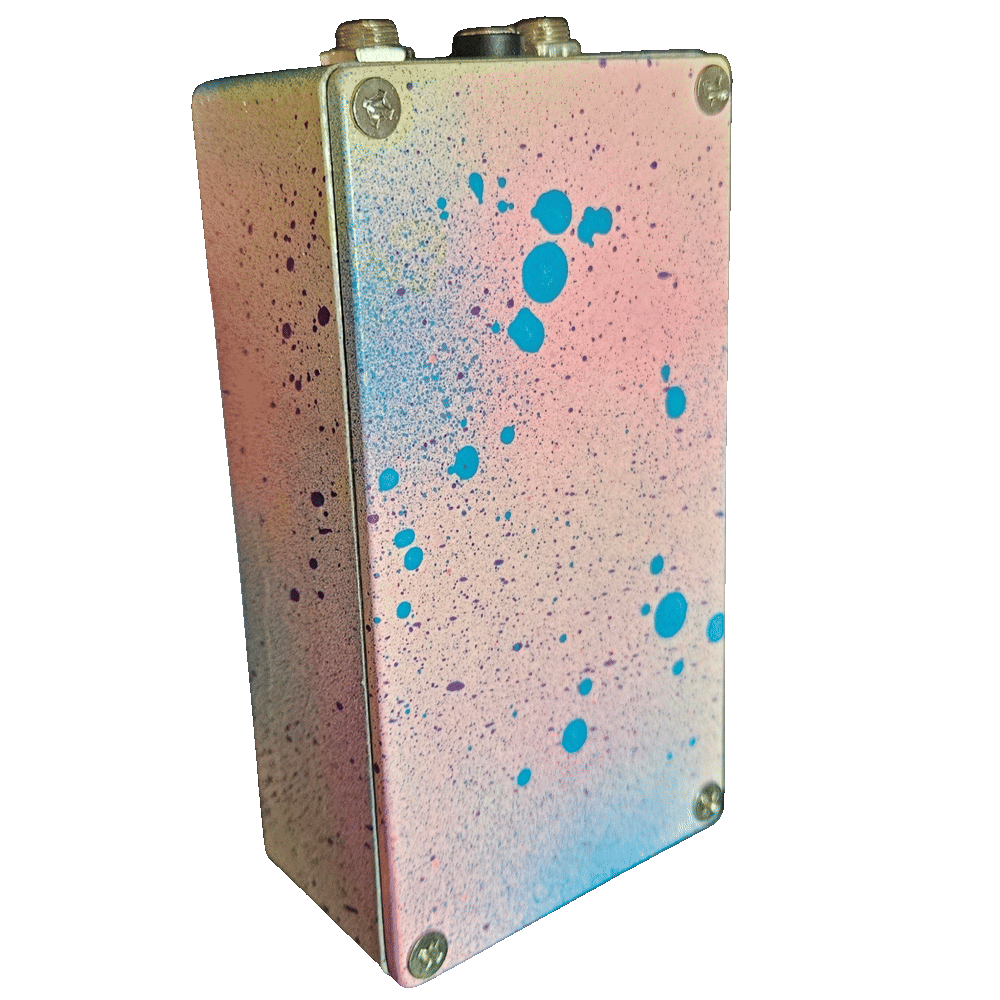 Back of the pedal: the bottom plate carries the same pink-and-blue speckle with bold turquoise droplets and a Phillips screw in each corner, with no label or serial plate. The two jacks and the DC socket are visible along the top edge.