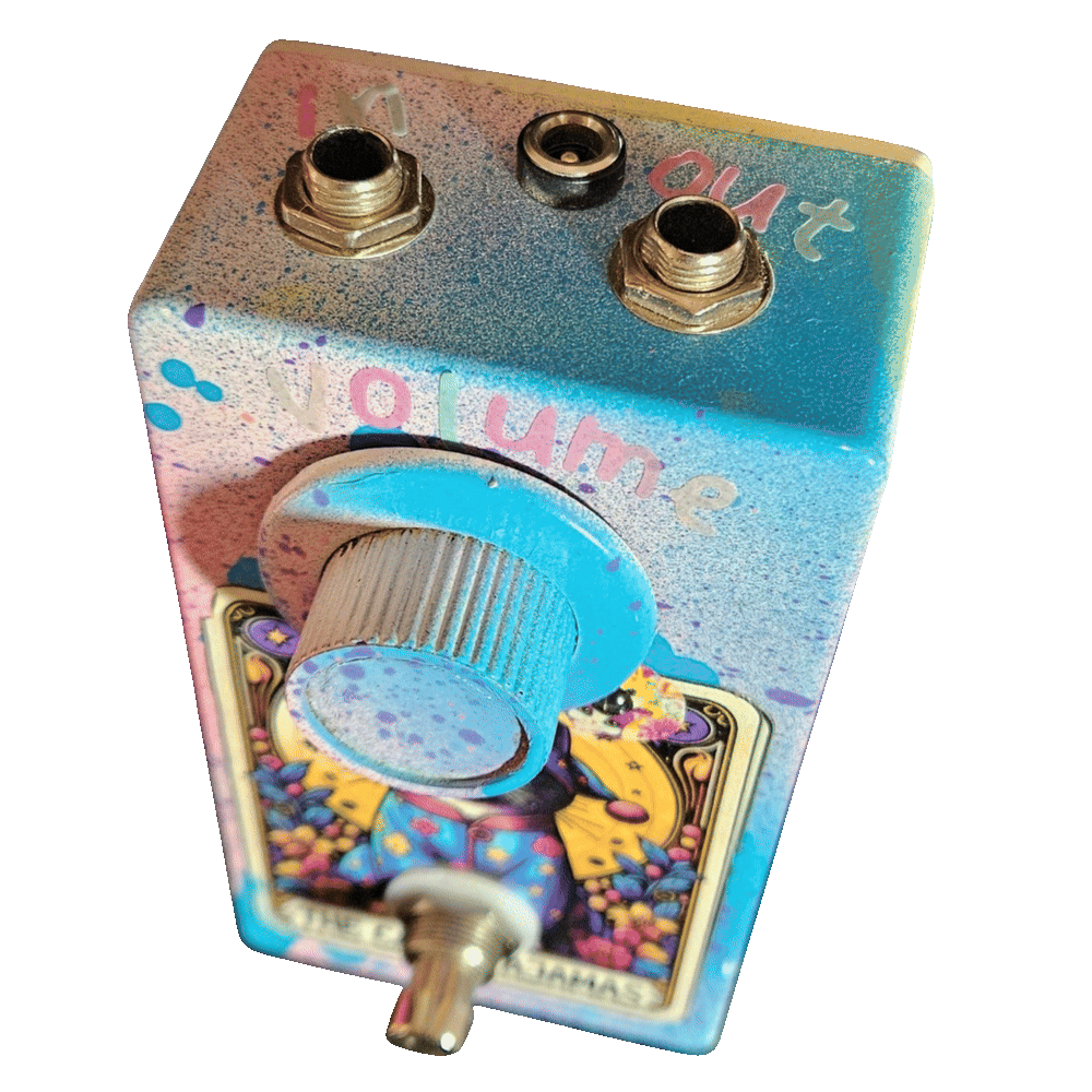 Top-down view of the enclosure: a 1/4-inch jack sits at each corner of the top edge, hand-lettered "in" on the left and "out" on the right, with a barrel DC power jack centred between them. Pastel letters spelling "volume" arc above the large light-blue knurled knob.