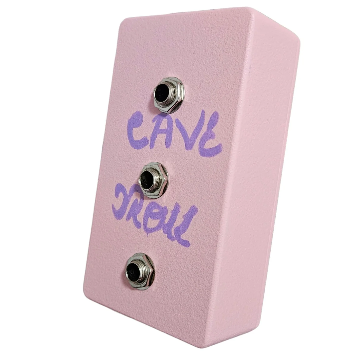 The same pink box turned further round, so the right flank and the face are both in view. CAVE TROLL reads across the face in purple and the three jack sockets run down it in a line. The flank is bare pink with a lightly textured powder-coat finish.