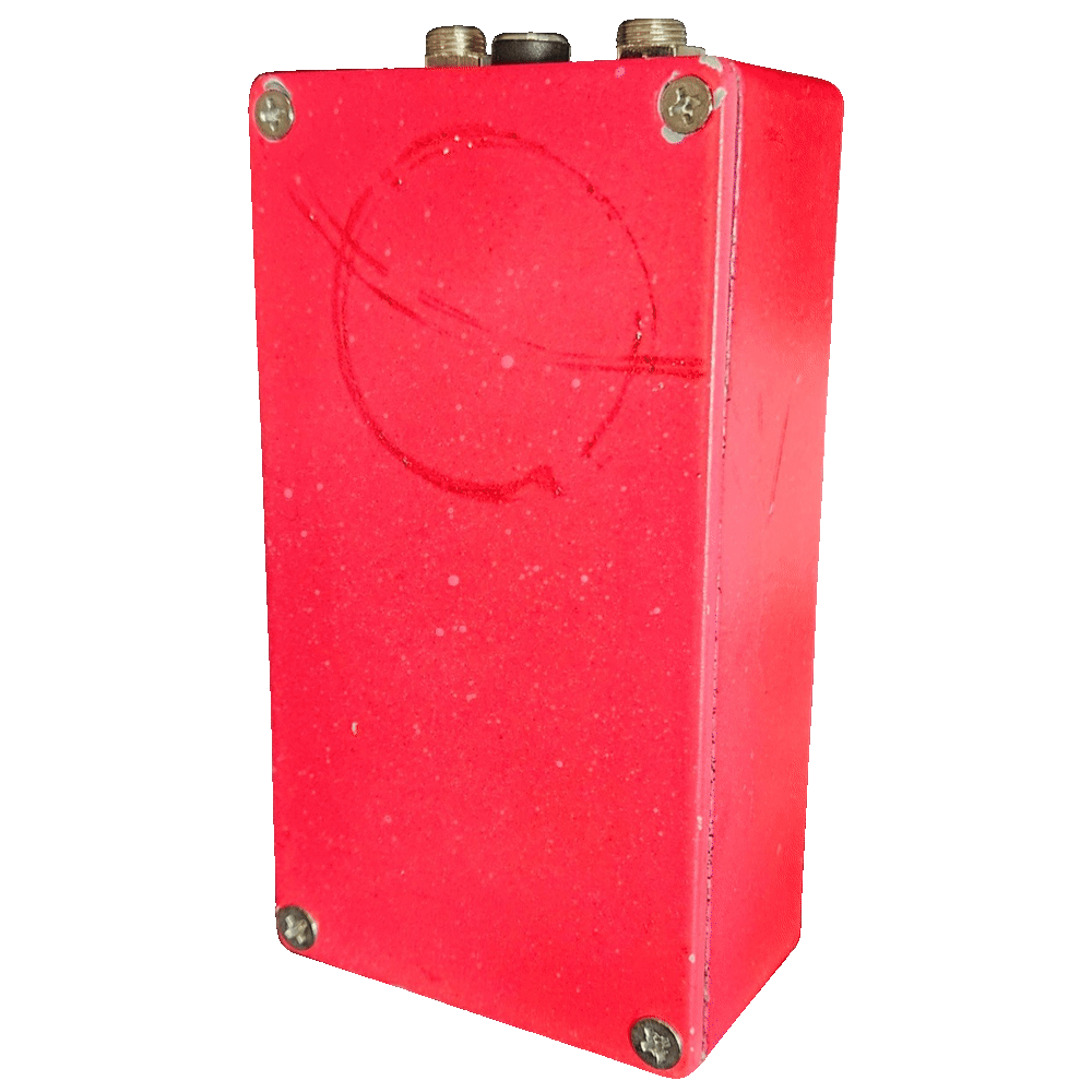Back of the pedal: a plain red bottom plate with a Phillips screw in each corner and a faint circular scuff worn into the paint near the top. The two jacks and the DC socket show along the top edge.