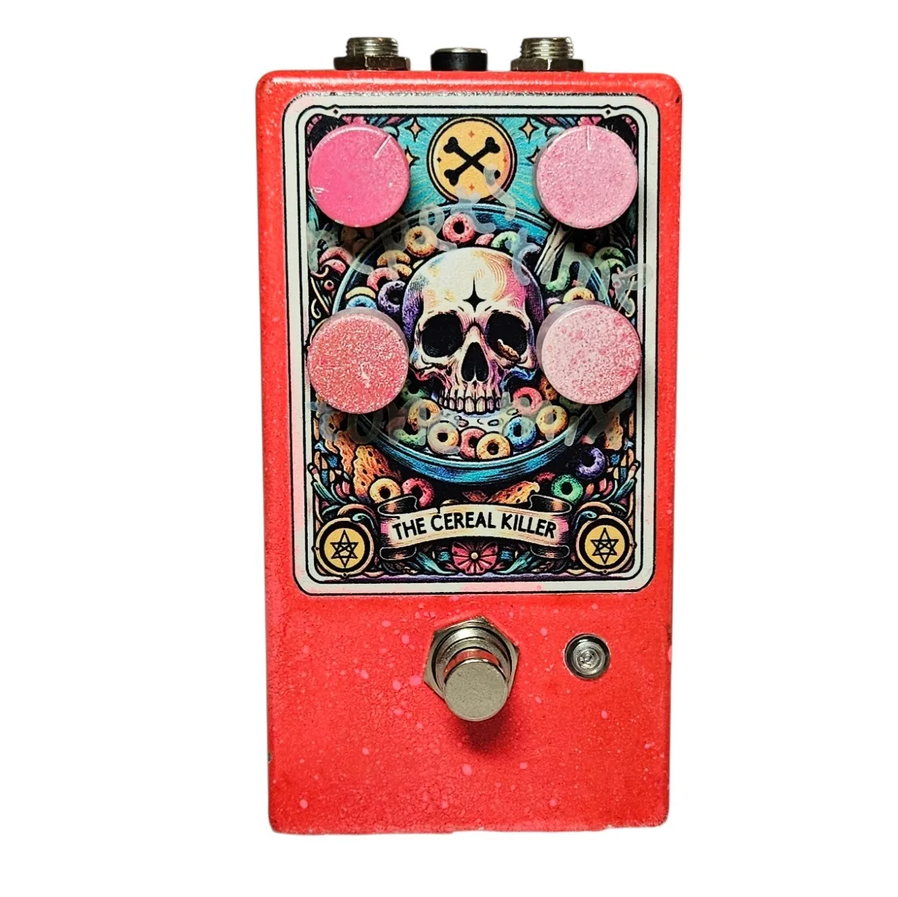 The Cereal Killer prototype pedal - red speckled enclosure with four dusty pink knobs and tarot-card skull-in-a-cereal-bowl artwork