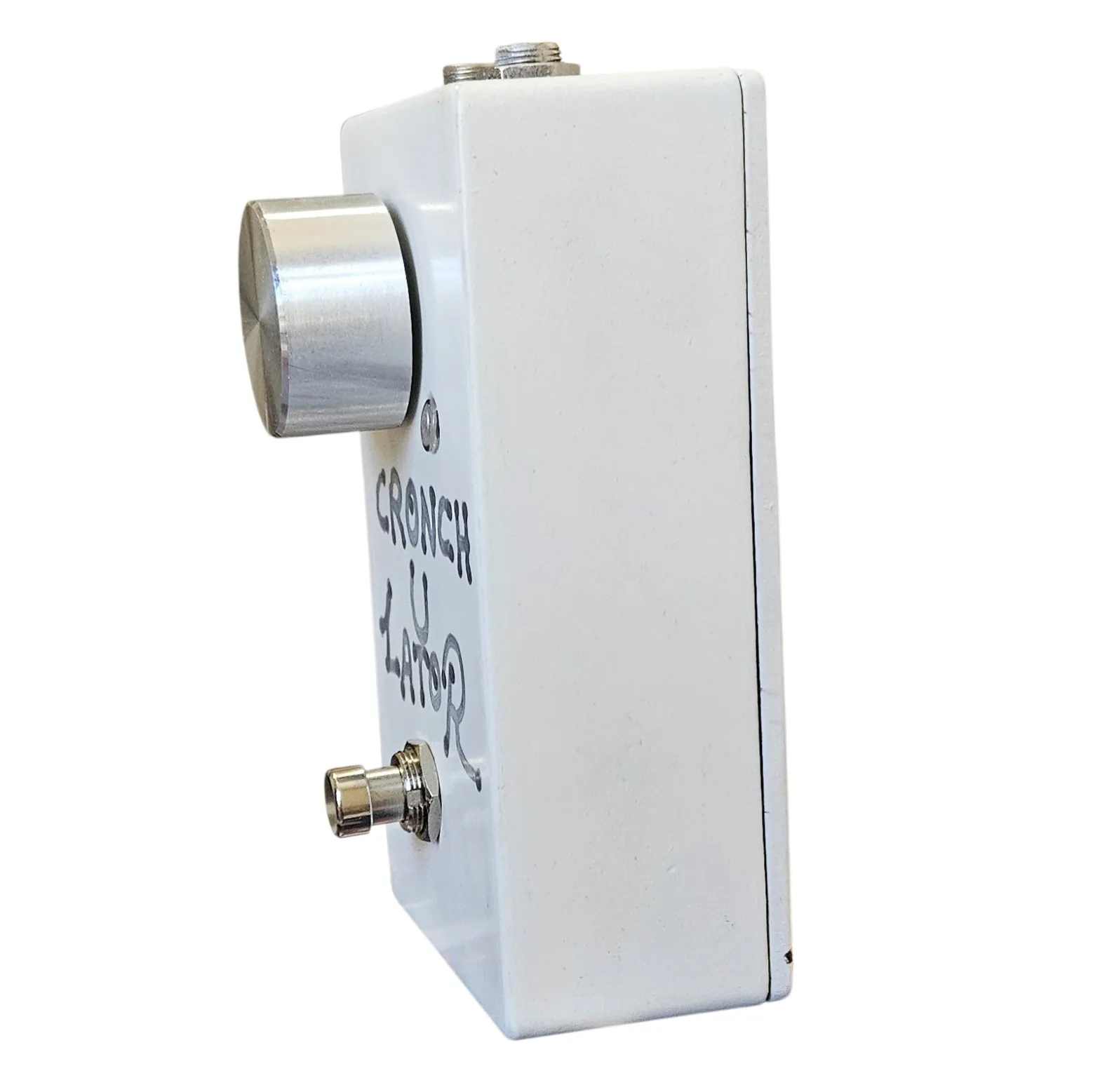 Cronch-u-lator pedal, angled right-side view - the white enclosure from the other side, the big silver knob standing proud of the face and the footswitch below.