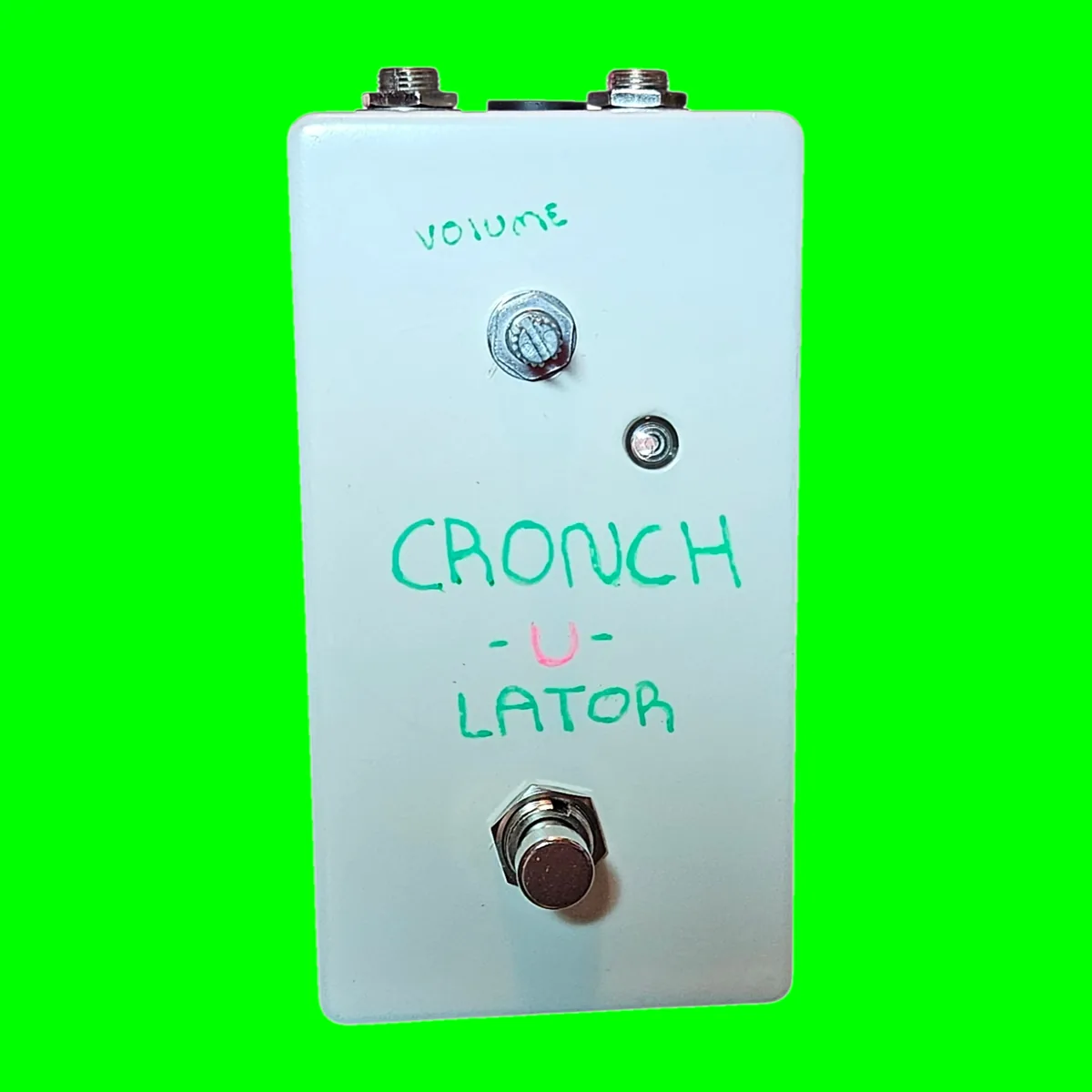 Cronch-u-lator pedal - pale pastel-blue enclosure with a single silver knob at the top labeled VOLUME in hand-lettered green marker, a small pink LED, and a 3PDT footswitch below hand-lettered CRONCH -u- LATOR in green and pink