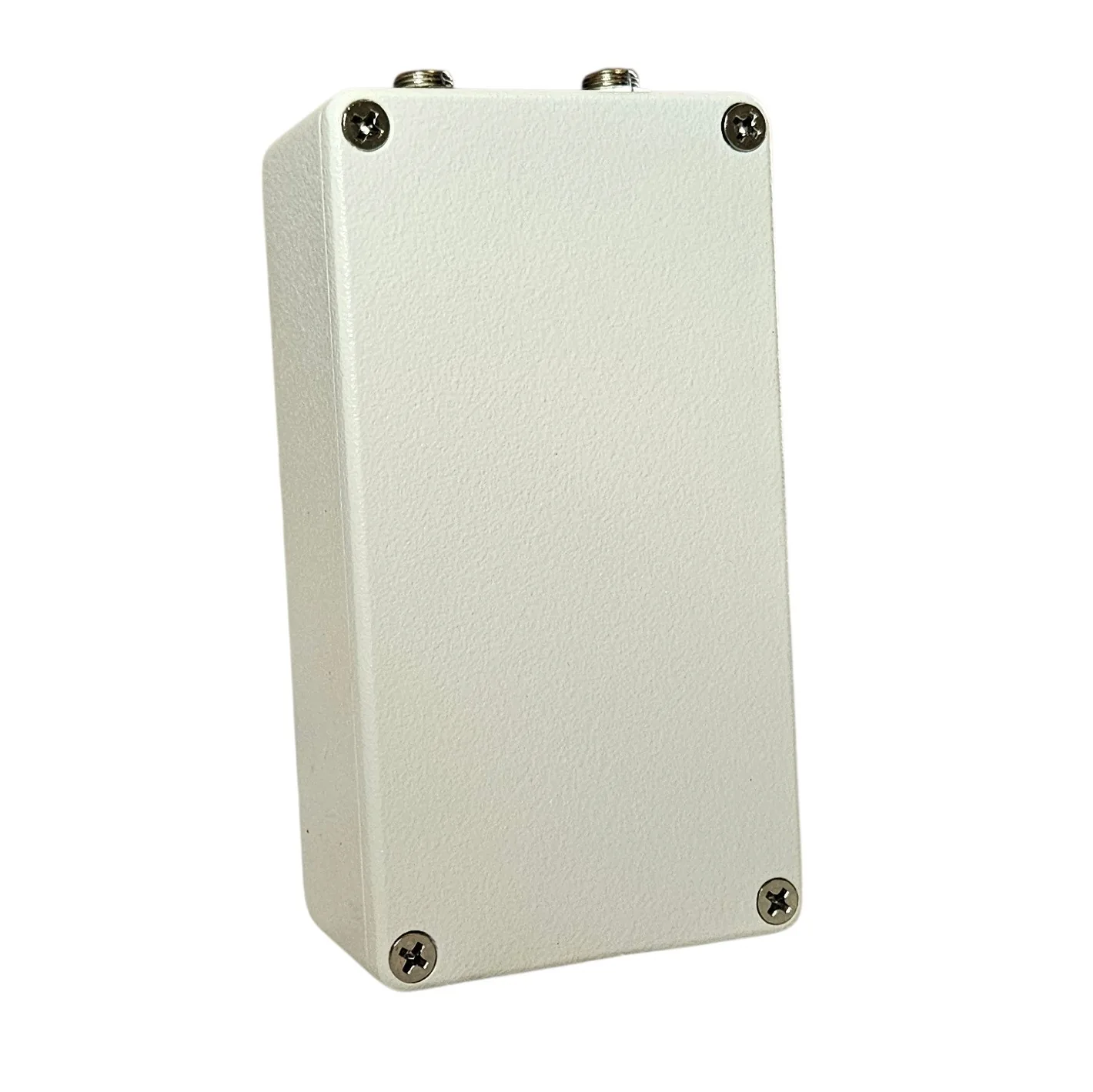 The back of the pedal: a plain white bottom plate with a cross-head screw in each corner and the jack sockets visible along the top edge.