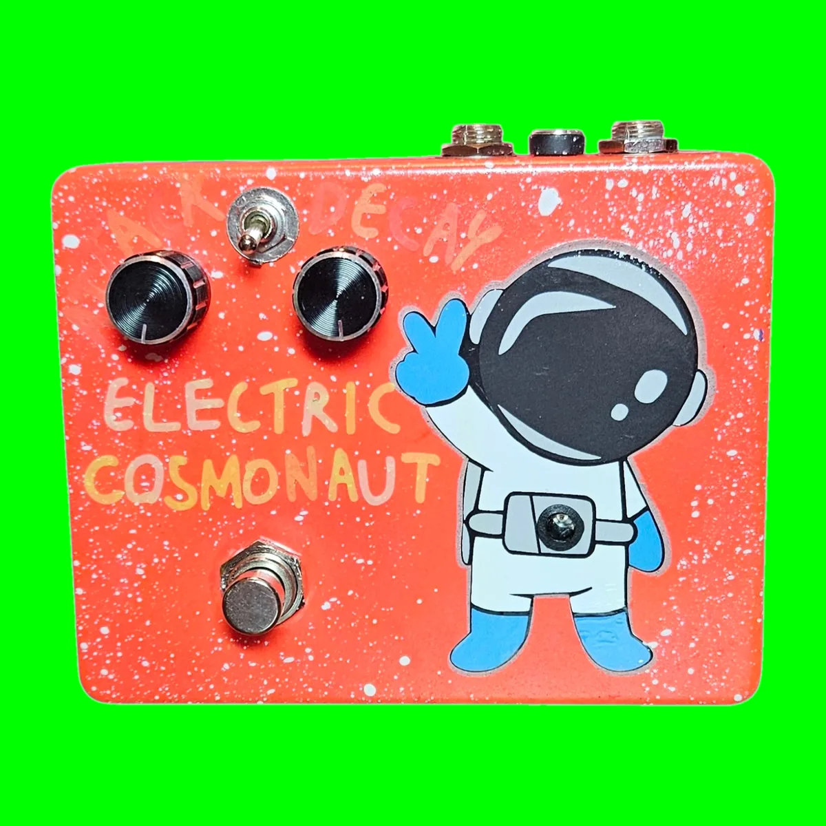Electric Cosmonaut pedal - orange speckled enclosure with cartoon cosmonaut artwork, engraved Attack and Decay knobs and a Blend toggle