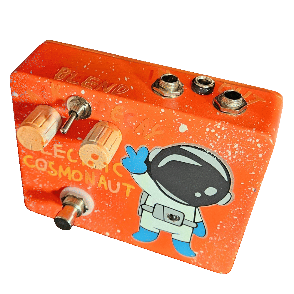 Top-down view of the wide enclosure: the top edge carries a 1/4-inch jack near each end with a DC power jack between them, and "OUT" engraved beside the right-hand jack. "BLEND" is engraved above the small toggle switch with "DECAY" to its right, above the two ribbed cream knobs.