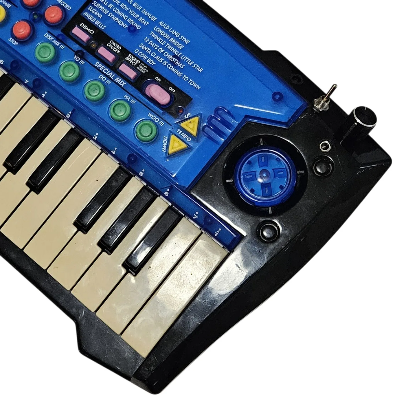 A close angled view of the right end. The added quarter-inch jack is set into the black case beside the round blue speaker grille, with a silver toggle switch on the top edge above it and the second black knob on the corner. On the blue panel are the five green SPECIAL MIX buttons, labeled DISK MIX, YO, DO, HA and WOO, all with three exclamation marks.