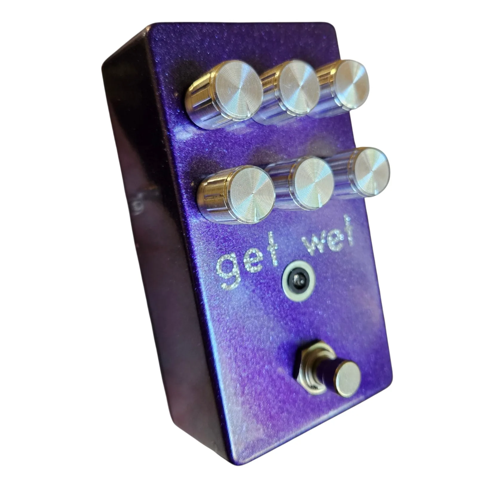 Get Wet pedal, angled view from the left showing the dark left side of the enclosure, the six chrome knobs foreshortened, the get wet lettering, the LED and the footswitch.