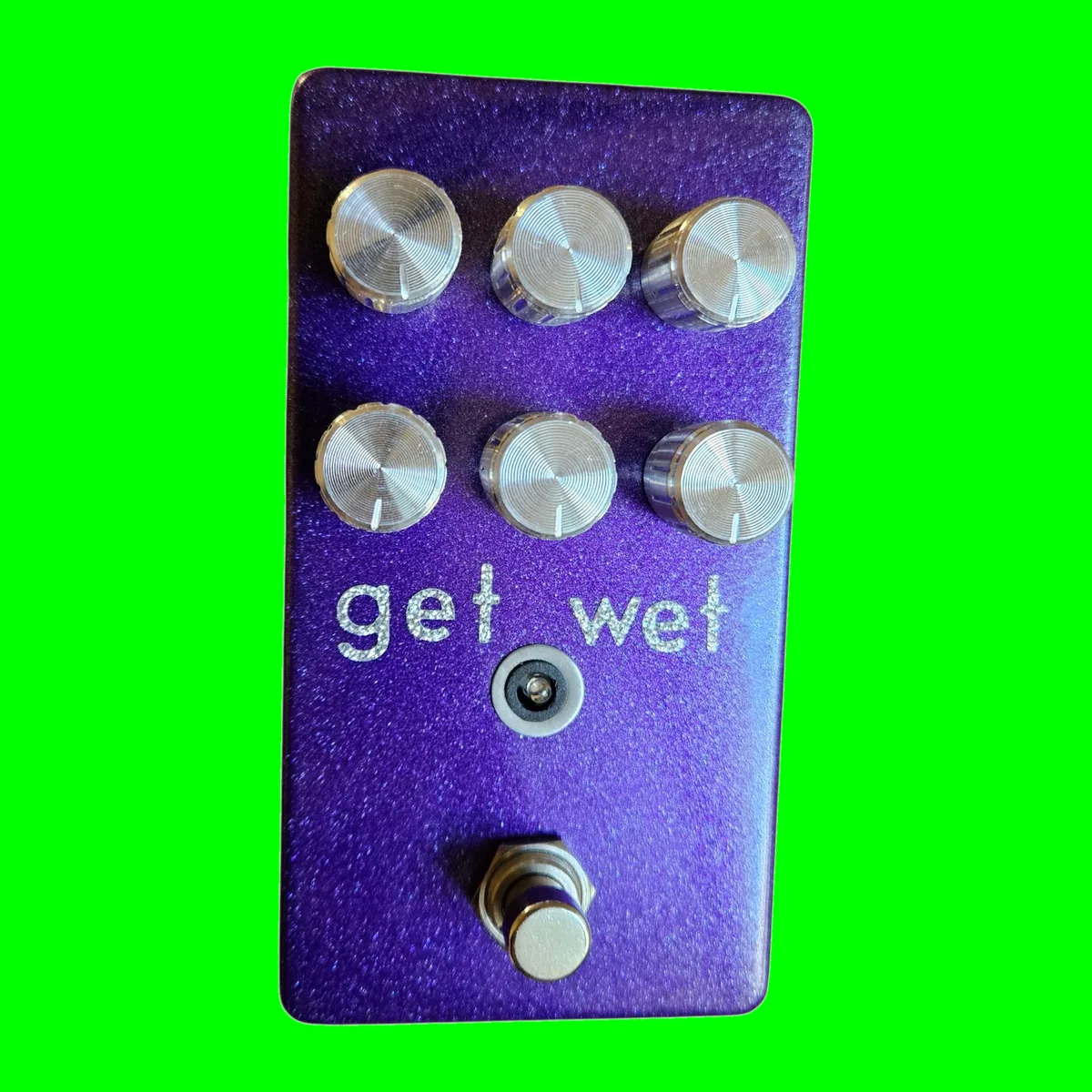 Get Wet pedal - metallic purple glitter enclosure, get wet hand-lettered in sparkly silver, six chrome knobs in two rows, LED and footswitch