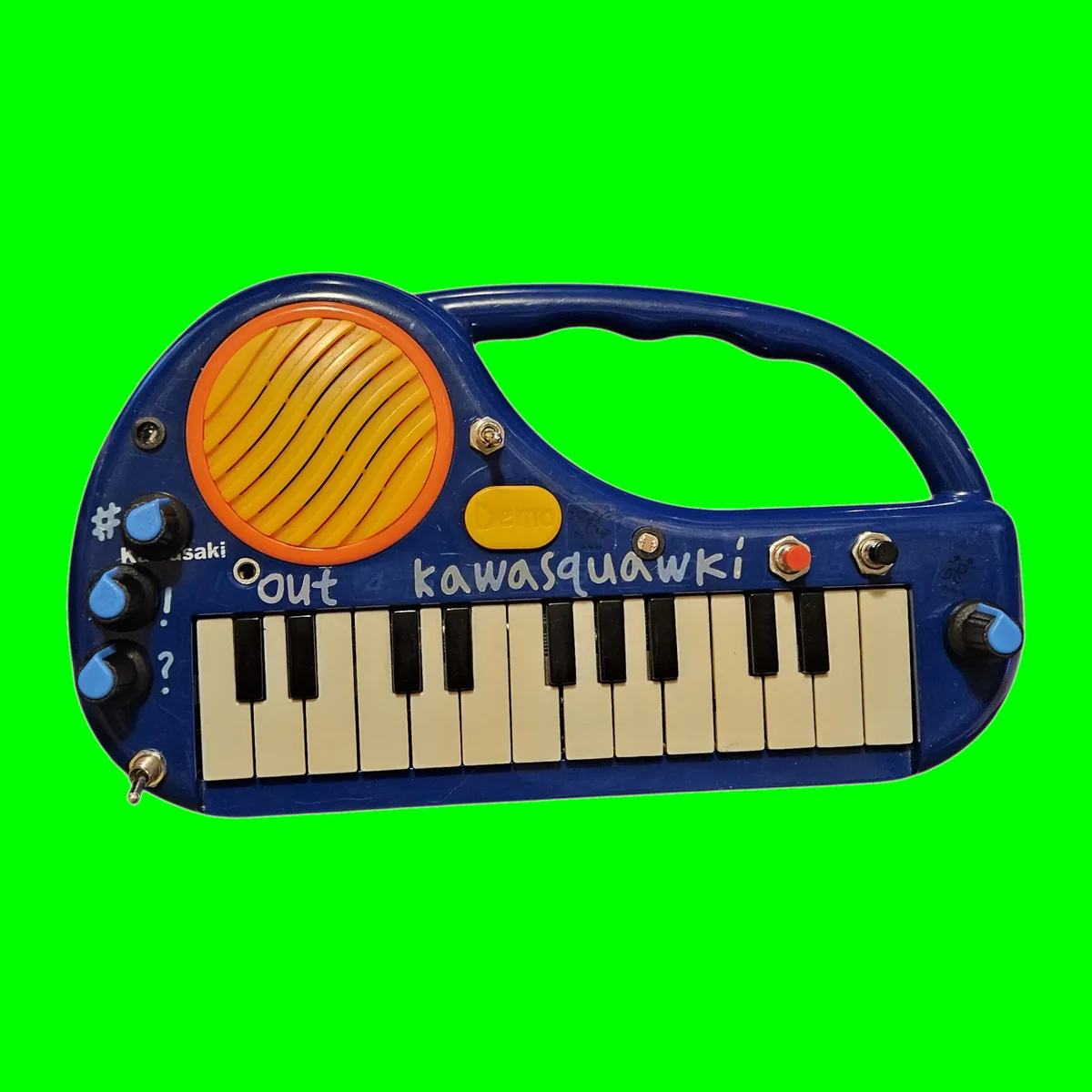 Kawasquawki - a dark blue Kawasaki toy keyboard with a carry handle and a big orange and yellow speaker grille, kawasquawki hand-lettered on the panel, with four added black knobs with blue pointers, a red record button, a black play button and three toggle switches