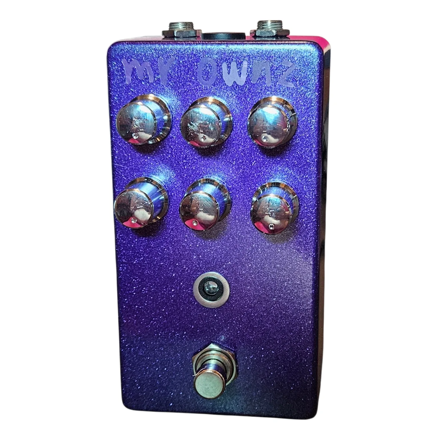 Mr. Ownz pedal, front view - a tall metallic-purple-glitter enclosure with six silver knobs in two rows of three, a small LED beneath, a 3PDT footswitch at the bottom, and mR OWNZ hand-lettered in silver marker at the top.