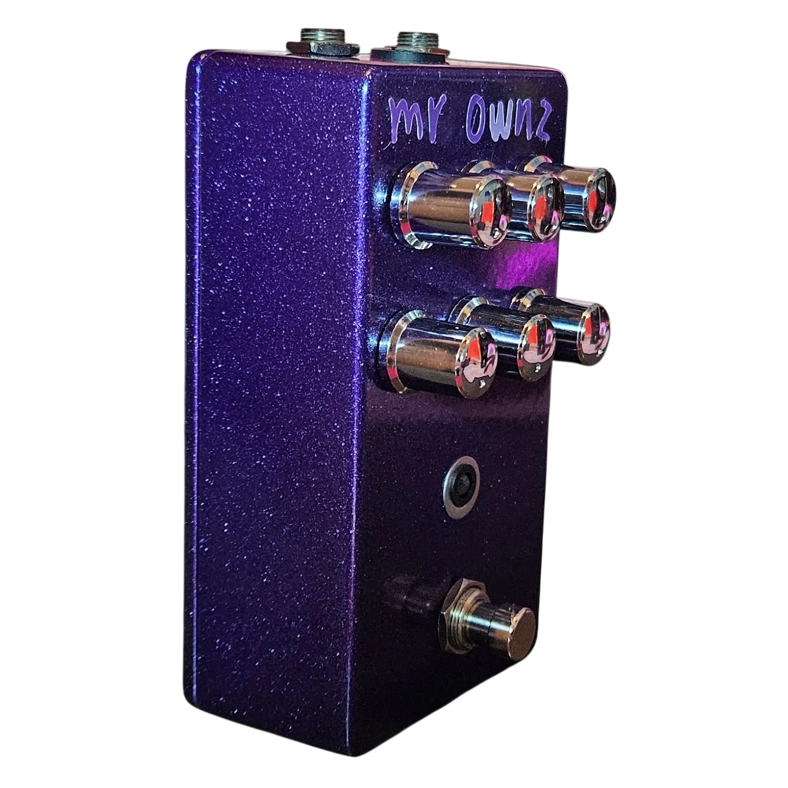 Mr. Ownz pedal, angled left-side view showing the enclosure depth, the input and output jacks along the top edge, and the knobs foreshortened.