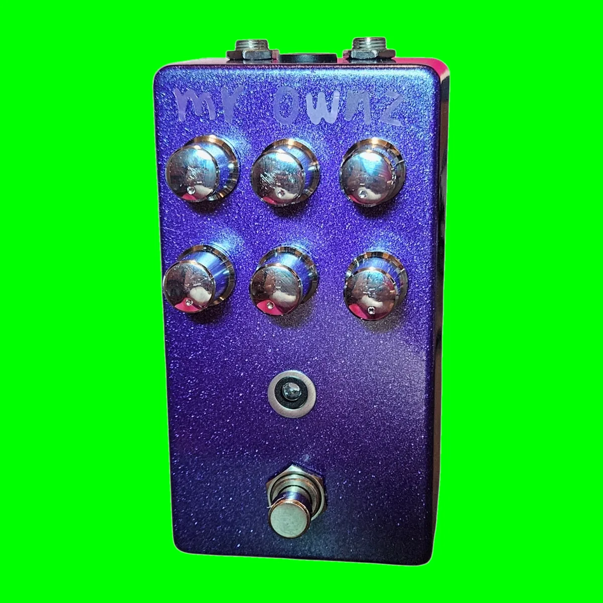 Mr. Ownz pedal - metallic purple glitter enclosure with six silver knobs in two rows of three, a small LED, and a 3PDT footswitch; hand-lettered mR OWNZ in silver at the top