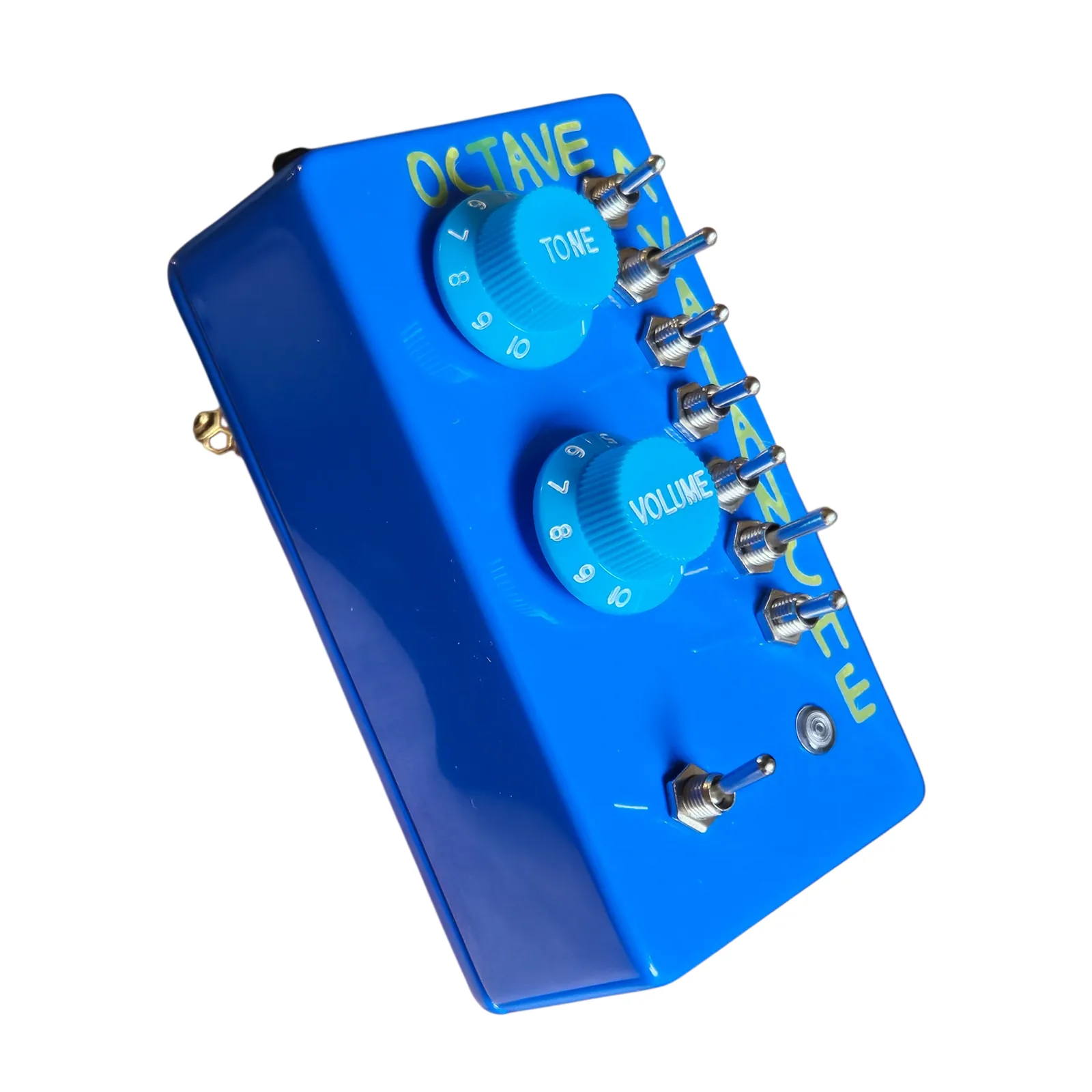 The Octave Avalanche from the left at a three-quarter angle, the blue side wall toward the camera, the two knobs and the column of seven toggles on the face.