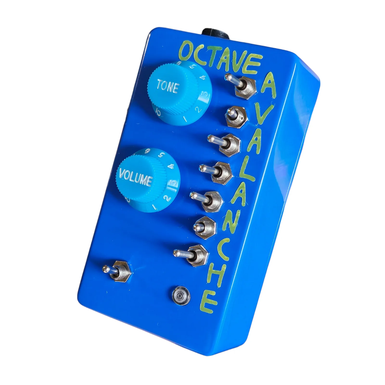 The Octave Avalanche from the right at a three-quarter angle, the two knobs, the seven toggles and the green lettering on the face, the right side wall toward the camera.