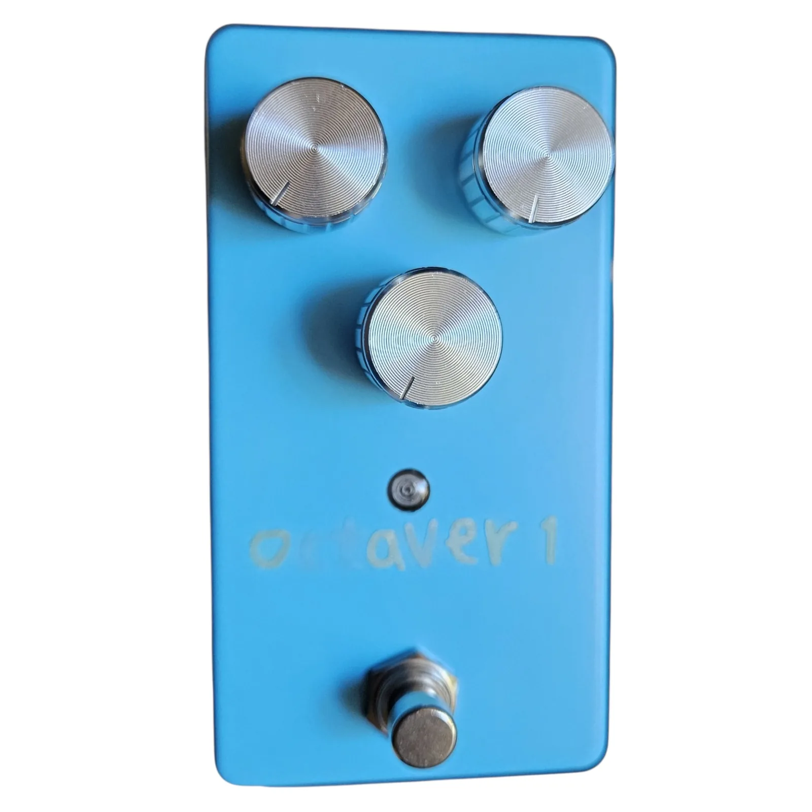 A matte sky blue box stood upright, seen face on. Two silver knurled knobs sit side by side near the top with a third centered below them, a small indicator LED under that, octaver 1 lettered faintly in pale paint, and a chrome footswitch at the bottom.