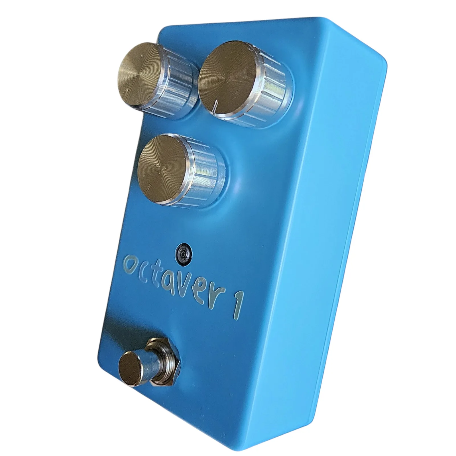 The blue box at a three-quarter angle from the right, the three silver knobs, the LED, the pale lettering and the footswitch along the face.