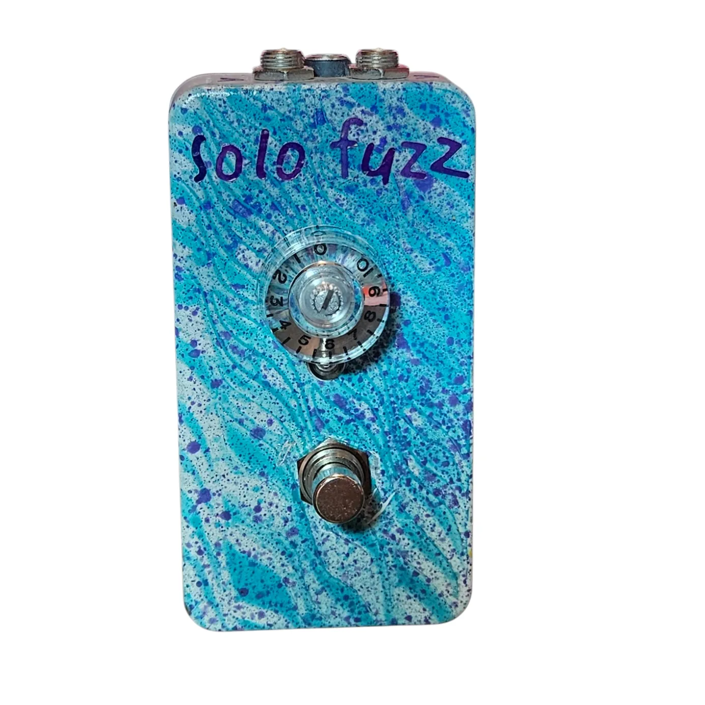 Solo Fuzz pedal, front view - white enclosure with teal-and-purple splatter, hand-lettered &ldquo;solo fuzz&rdquo; in purple, and a single clear Volume knob with a skirt numbered to 10.
