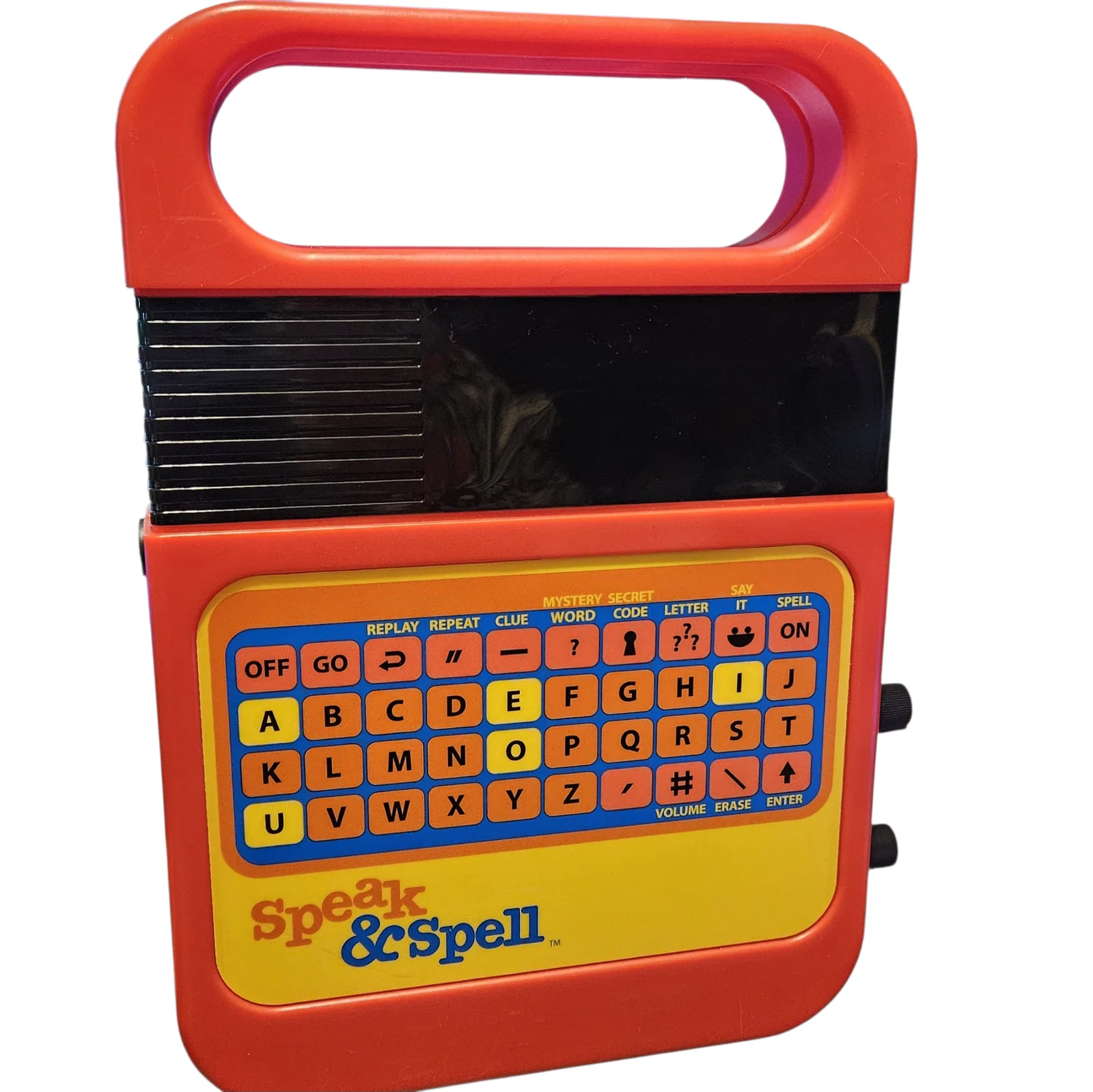 The front of a red Texas Instruments Speak and Spell, standing upright: the molded carry handle across the top, the black display window below it, and the yellow keypad with orange letter keys and the Speak and Spell logo. Completely unmodified.