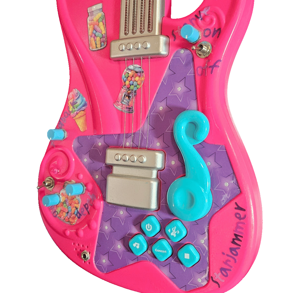 Close-up of the lower body: four small turquoise knobs and two chrome toggle switches added into the hot-pink shell around the original silver pickups, the turquoise treble-clef whammy bar and the factory buttons marked with a power symbol, a music note and "Concert". Handwritten purple marker labels read "starve", "on" and "off" beside the upper toggle and "depth" beside two of the knobs; a silver quarter-inch jack is mounted at the bottom edge next to the speaker slots, and "starjammer" is written in purple marker along the lower right curve. Candy stickers &mdash; a jar of sweets, a gumball machine, an ice cream cone and a heart-shaped candy jar &mdash; are stuck across the pink areas.