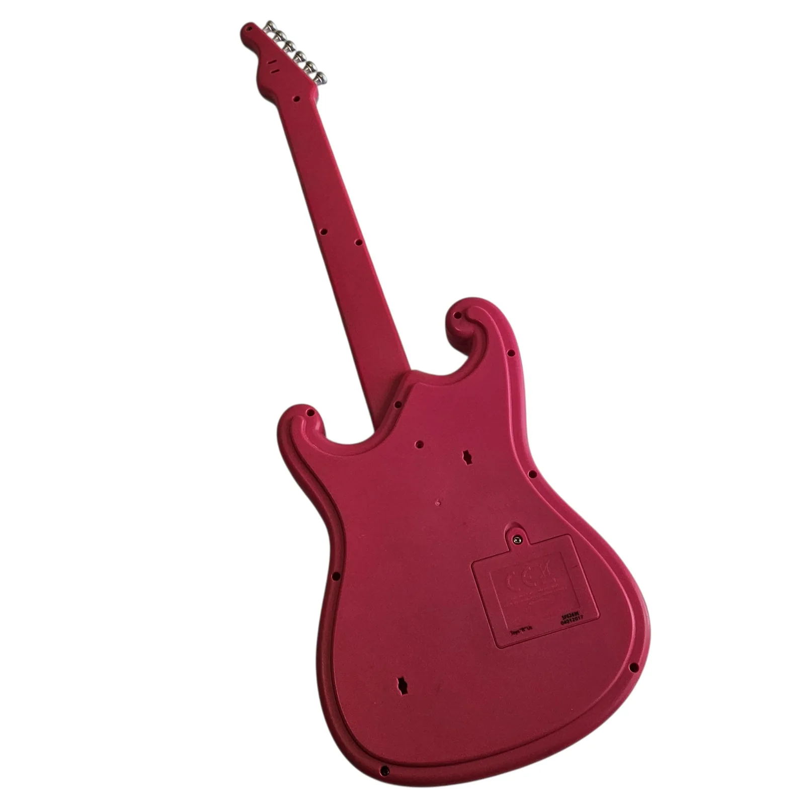 The back of the guitar, plain pink molded plastic with a screwed panel in the middle of the body and mounting holes around the edge.