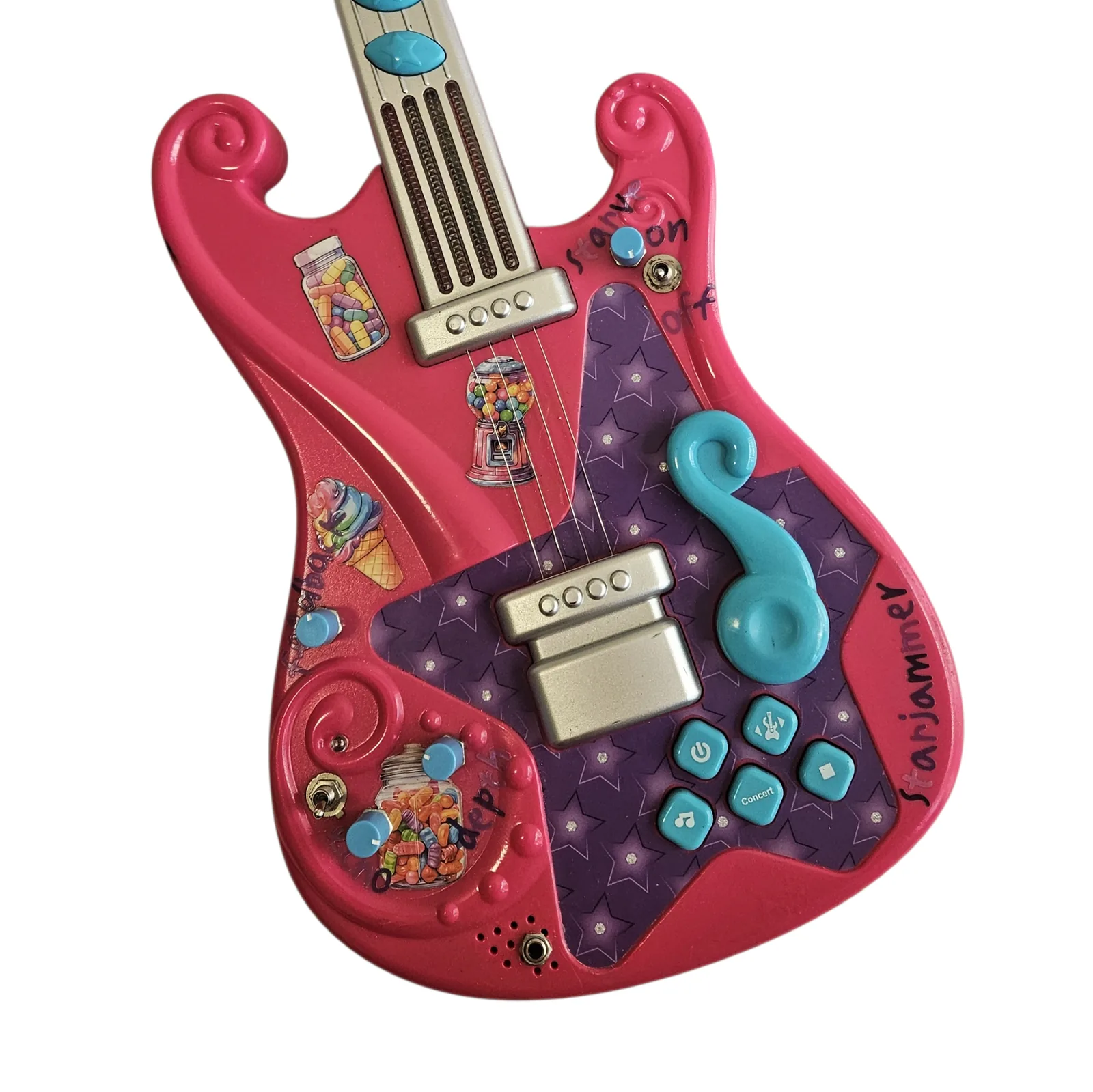 Close on the body controls: rows of small teal buttons, a silver rocker switch and a raised teal treble clef, surrounded by the sticker collage, with Starjammer hand-lettered at the edge.