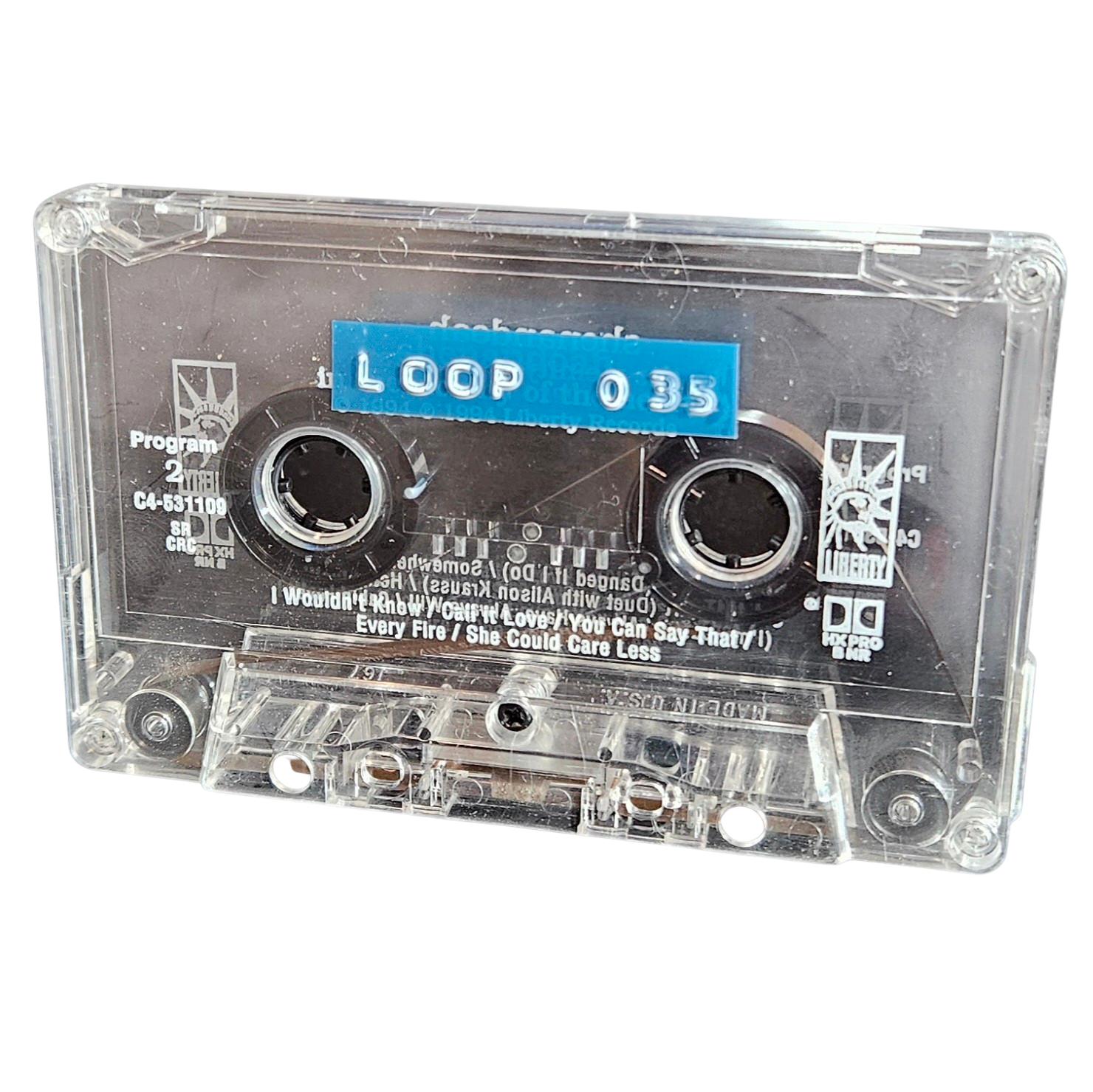 Clear cassette shell labeled Loop 035 on a blue strip, recycled from a Liberty Records country compilation