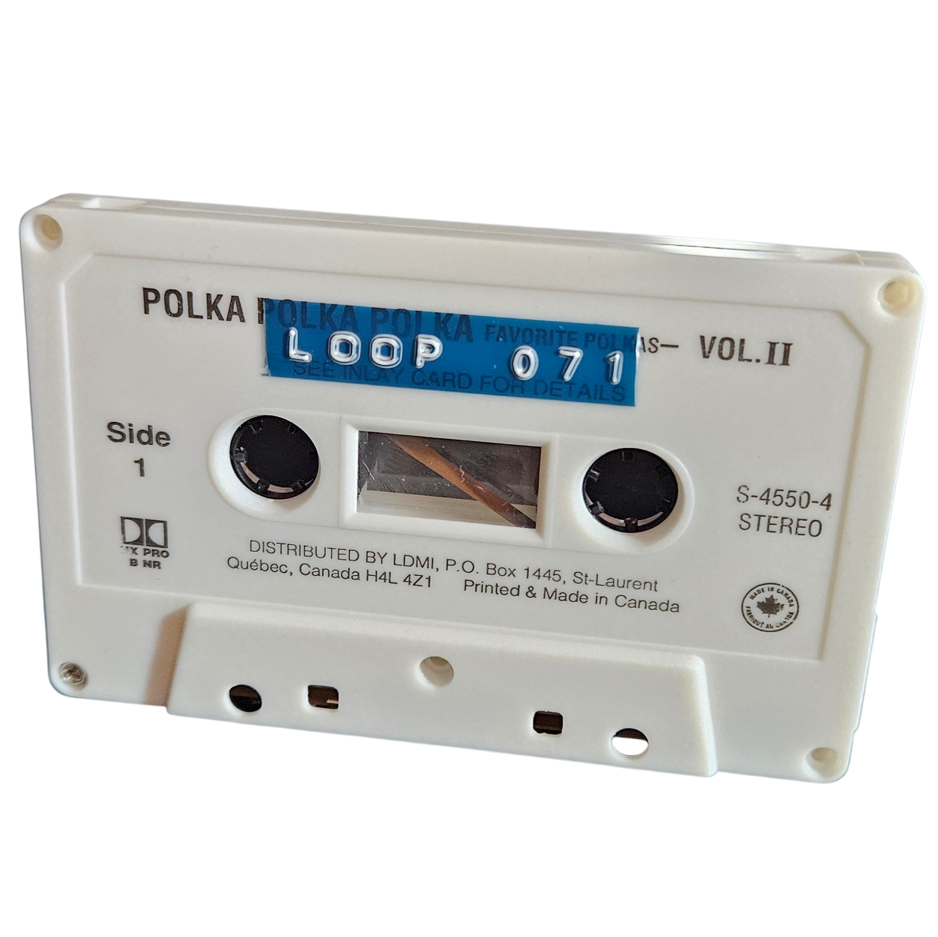 White cassette shell labeled Loop 071 on a blue strip, recycled from a Polka Polka Polka Vol. II cassette made in Canada
