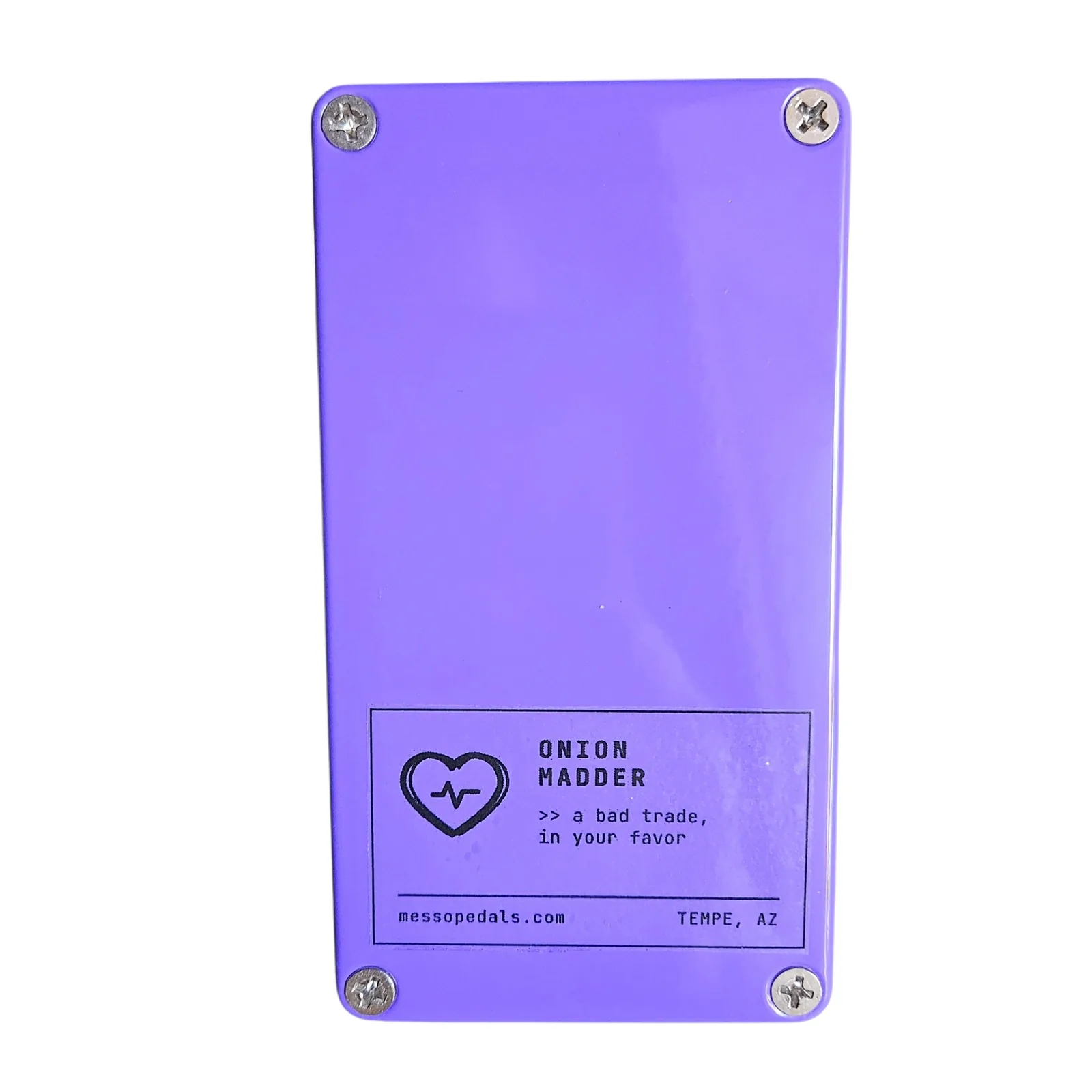 The back plate of the purple box with a screw in each corner and a white label near the bottom: a heart with a heartbeat line, ONION MADDER, a bad trade, in your favor, messopedals.com and TEMPE, AZ.