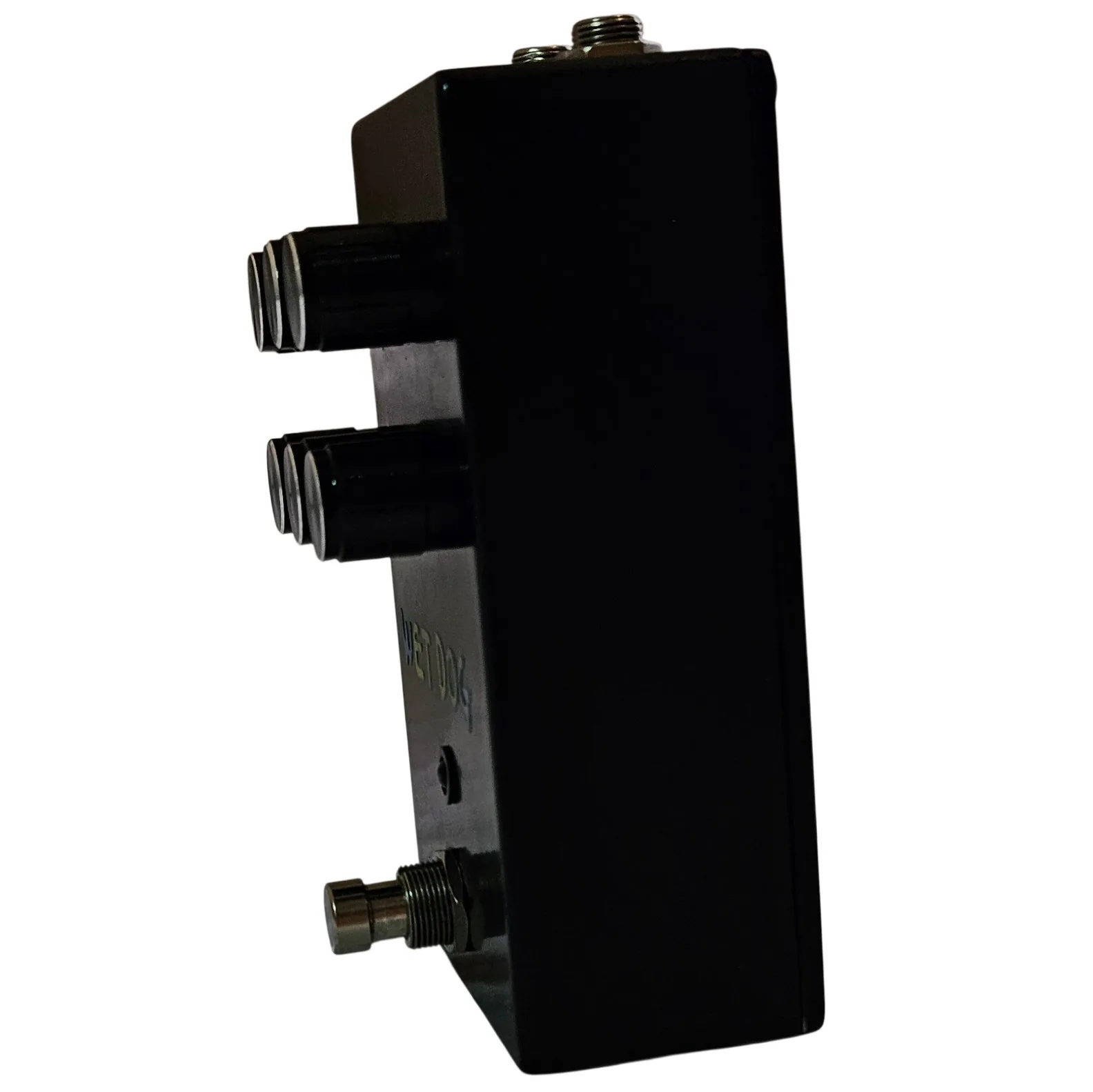 A near side-on view of the pedal, the six black knobs strongly foreshortened into two stacked rows against the plain black flank, with the footswitch projecting from the lower edge.